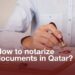 A person stamping a document with a wax seal, representing the notarization process in Qatar. The text overlay reads, 'How to notarize documents in Qatar?' highlighting the legal services available for notary attestation in Qatar.