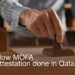 Close-up image of a person stamping a document, symbolizing the process of MOFA attestation in Qatar. The text overlay reads, 'How MOFA attestation done in Qatar?' This visual highlights the official and formal nature of the attestation process required for legalizing documents in Qatar, making it essential for various legal and administrative procedures.