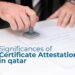 A close-up image of a person stamping a document, symbolizing the process of certificate attestation. The text overlay reads, "Significances of Certificate Attestation in Qatar."